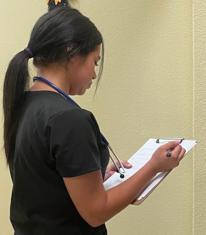 student reviewing patient paperwork student reviewing patient paperwork