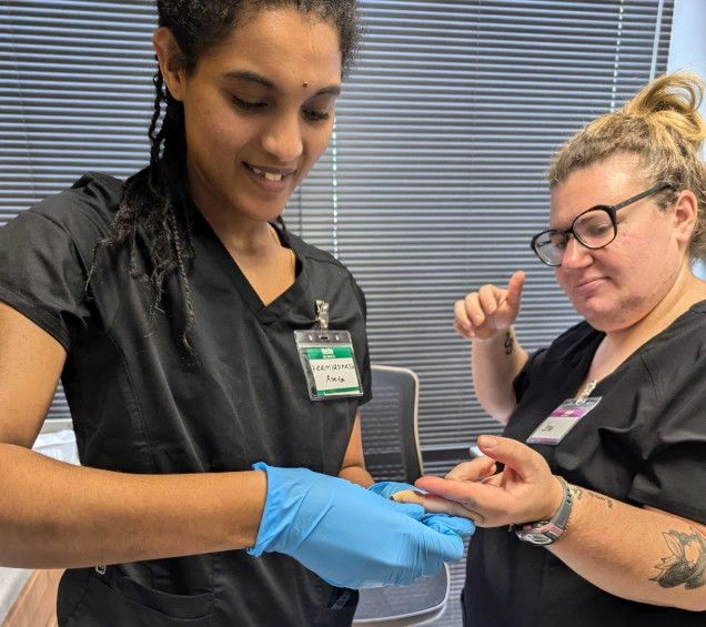 student practicing finger prick for blood draw student practicing finger prick for blood draw