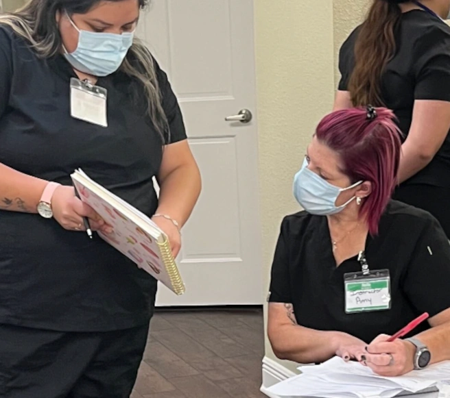 instructor reviewing a diagram with a medical assistant student instructor reviewing a diagram with a medical assistant student