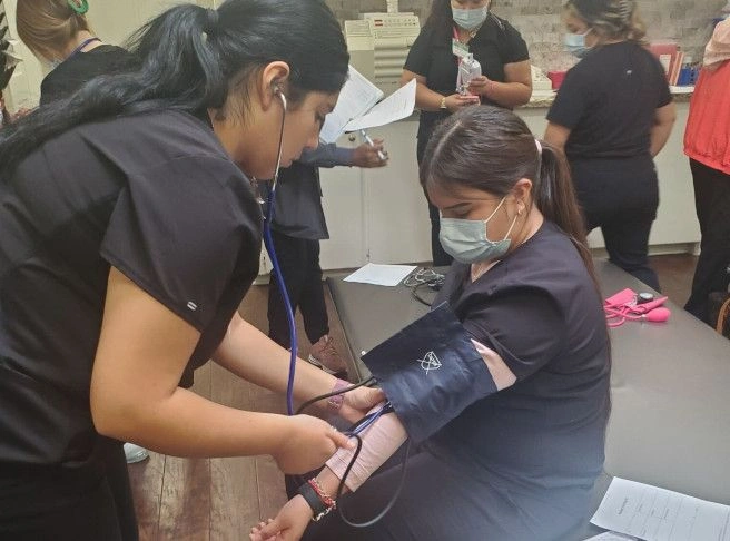 students training to take blood pressure from patients students training to take blood pressure from patients