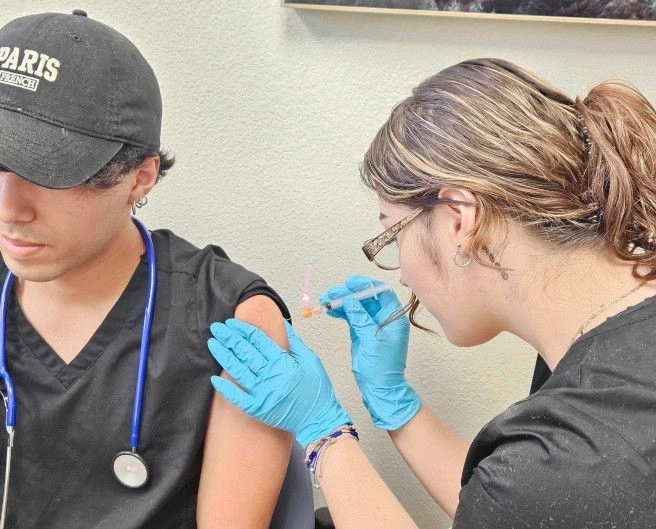 students training to administer injection students training to administer injection